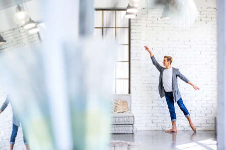 A handsome young male Ballet dancer practicing in a Loft style A