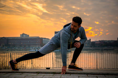 Young man stretchingの写真素材