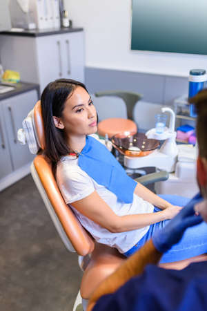 A female patient waiting for treatment in a dental studioの写真素材