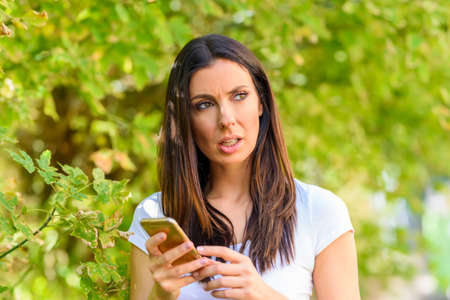 A woman receiving bad news on her Smartphone