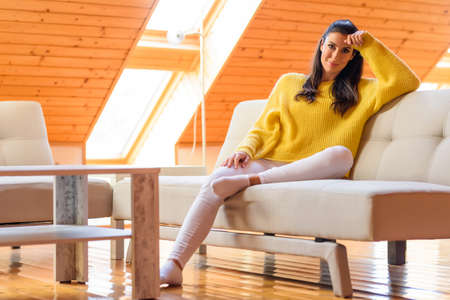 Portrait of a beautiful woman relaxing on the sofa