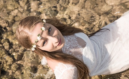 Young woman laying in the oceanの写真素材