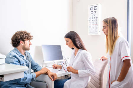 A female Doctor with a patient in the consultation roomの写真素材