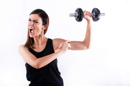 Young woman showing musclesの写真素材