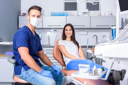 A young Dentist consulting a female Patient in the dental studioの写真素材