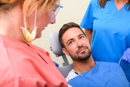 A handsome male patient waiting to receive a dental treatment in a dental studio