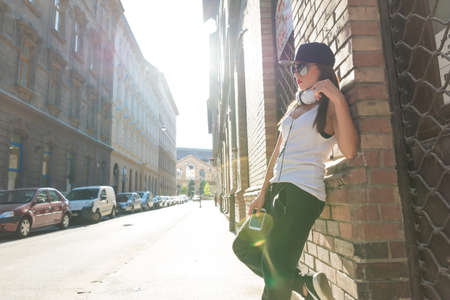 Hip hop girl with headphones in a urban environmentの写真素材