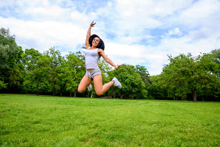 Beautiful young sporty girl in a parkの写真素材