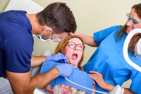 A patient getting attended and treatment in a dental studioの写真素材