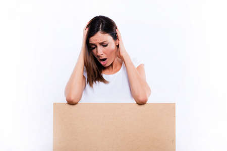 Worried woman with a signboardの写真素材