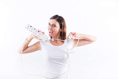 A beautiful young woman feeling happy with power cables in her handsの写真素材
