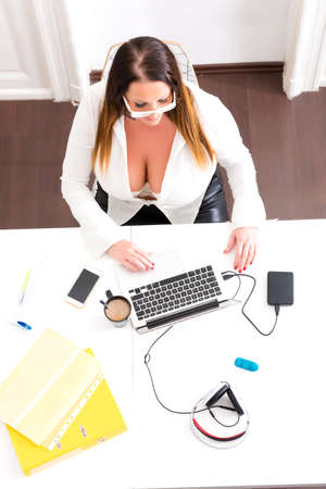 Big and Beautiful Secretary working in a officeの写真素材