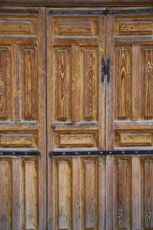 An old wooden vintage door of a historic building.