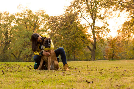 Beautiful young woman with her Dog in the Parkの写真素材