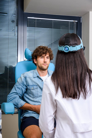A male patient getting attended by a ENT medical specialist forの写真素材