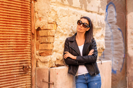 Fashion Portrait of a young woman in decayed European urban neigの写真素材