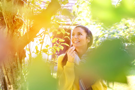A beautiful woman eating wine grapes on a fieldの写真素材
