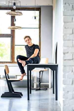 A young handsome Dancer relaxing in a loft style apartmentの写真素材