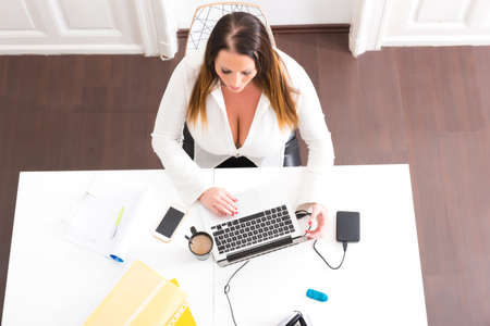 Big and Beautiful Secretary working in a officeの写真素材