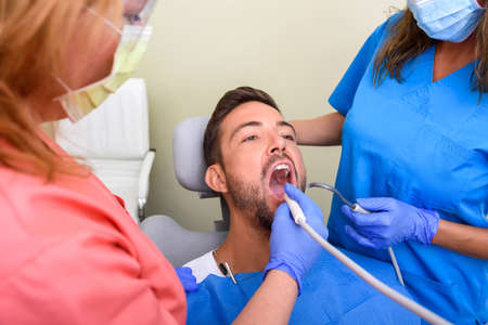A patient getting treatment in a dental studio