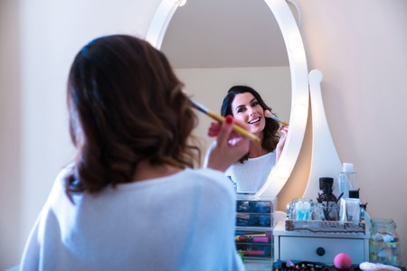 A beautiful young woman at a makeup tableの写真素材