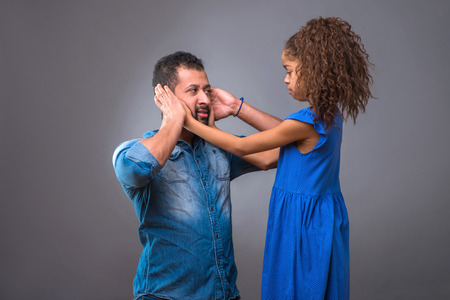 Young black father with his teenage daughterの写真素材