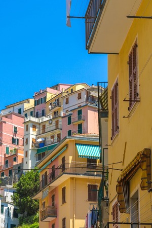 View over the the historic architecture of Cinque Terre, Italy with colourful houses on a sunny day.の写真素材