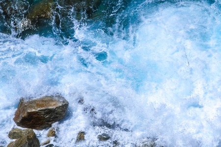 Rocks in the blue Mediterranean Sea on a bright sunny day.の写真素材