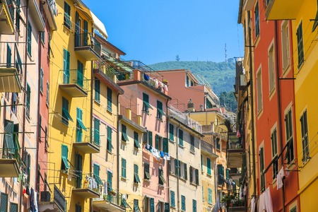 View on the beautiful colourful houses with clothes drying in the sunny daylight in Cique Terre,...