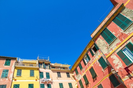 View on the beautiful colourful houses with clothes drying in the sunny daylight in Cique Terre, Italy.の写真素材