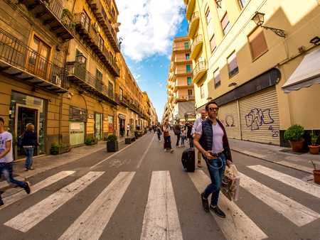 PALERMO, ITALY - CIRCA JUNE 2018: View on walking people as they pass by on the historic streets of the city centre on a sunny day circa June 2018 in Palermo, Italy.のeditorial素材