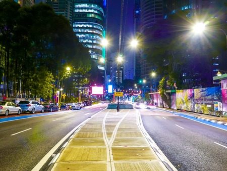 KUALA LUMPUR, MALAYSIA - CIRCA FEBRUARY 2018: View of busy street as traffic and pedestrians pass by in the centre of the city at night circa February, 2018 in Kuala Lumpur, Malaysia.のeditorial素材