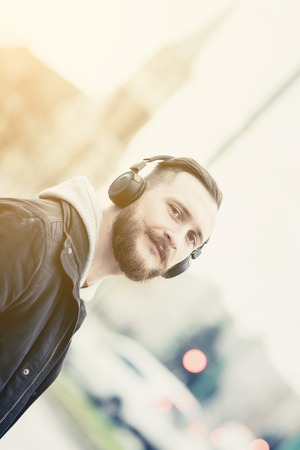 A retro style portait of a smiling young hipster man in an urban environment.の写真素材