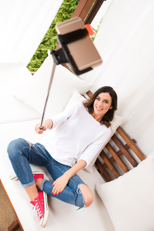 A beautiful young woman on the terraceの写真素材