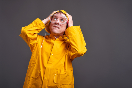 Man in yellow raincoatの写真素材