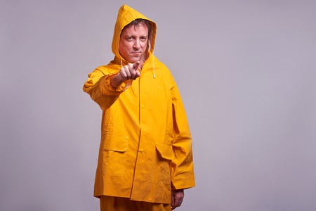 Man in yellow raincoatの写真素材