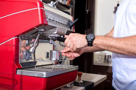 Young man making coffeeの写真素材