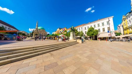 PECS, HUNGARY - AUGUST 15: View on the main square in historic centre of the city as people pass by...