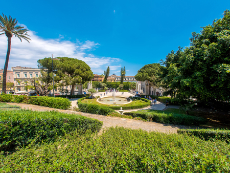 CATANIA, ITALY - CIRCA JUNE 2018: View on people as they pass by at the historic Bellini Garden park on a sunny day circa June 2018 in Catania, Italy.のeditorial素材