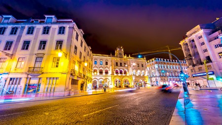 LISBON, PORTUGAL - CIRCA JANUARY 2018: View of the illuminated buildings in the centre of the city as people and traffic pass by at night circa January 2018 in Lisbon, Portugal.のeditorial素材
