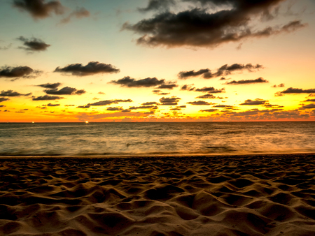 View of the colours of an amazing sunset over the tropical beach.の写真素材
