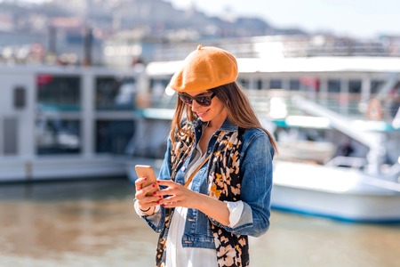 Portrait of a beautiful woman in front of a touristic boat.