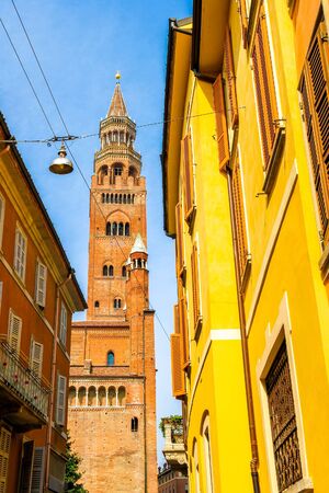 View on the famous Torrazzo bell tower with historic architectures in Cremona, Italy on a sunny day.の写真素材