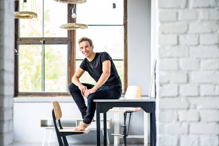 A young handsome Dancer relaxing in a loft style apartmentの写真素材
