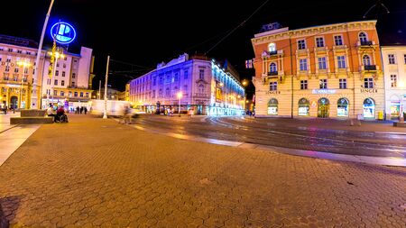 ZAGREB, CROATIA - CIRCA AUGUST 2019: Vew on pedestrians and tourists as they pass by on the main square of the city at night circa August 2019 in Zagreb, Croatia.のeditorial素材
