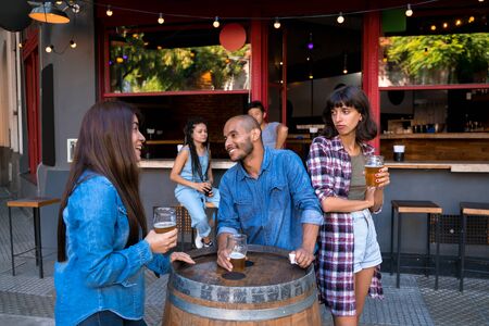 A latin man flirting with a woman while his girlfriend is left out and jealous.