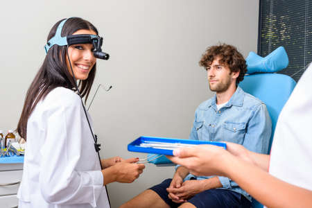 A female ENT specialist during a examination
