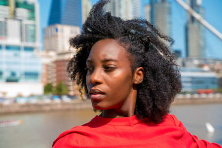 A happy black woman enjoying a sunny day in Puerto madero in Buenos Aires, Argentina.の写真素材