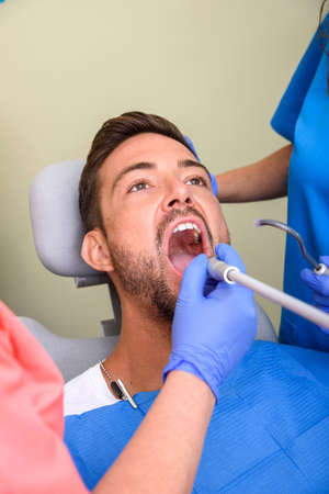 A patient getting treatment in a dental studioの写真素材