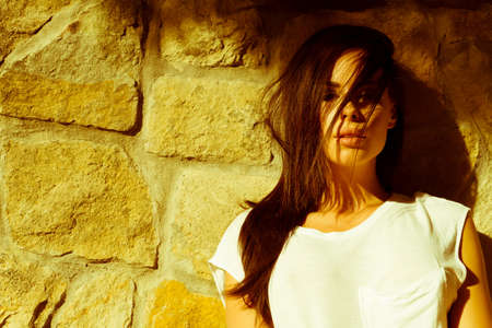 A outdoor Portrait of a beautiful young woman in the sunlight.